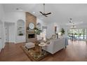 Inviting living room with a brick fireplace, built-in shelves, and seamless access to the backyard and pool at 633 N Longview Pl, Longwood, FL 32779