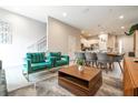 Open-concept living room and dining area featuring modern decor and furnishings at 7572 Sunny Dreams Ln, Kissimmee, FL 34747