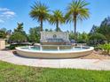 Community entrance featuring a beautiful fountain with palm trees at 8215 Roseville Blvd, Davenport, FL 33896