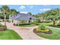 Beautiful one-story home features a circular driveway and mature landscaping for ultimate curb appeal at 8713 S Bay Dr, Orlando, FL 32819