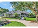 Charming one-story home features a well-manicured lawn and mature tree providing ample shade at 8713 S Bay Dr, Orlando, FL 32819