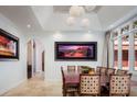 Bright dining room with large table, modern lighting, and arched doorways at 9724 Chestnut Ridge Dr, Windermere, FL 34786