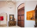 Elegant foyer with a chandelier, wooden door, and stylish decor at 9724 Chestnut Ridge Dr, Windermere, FL 34786