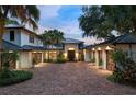 Elegant home with brick driveway, three garages, palms, and well maintained landscaping at 9724 Chestnut Ridge Dr, Windermere, FL 34786