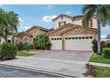 Attractive two-story home boasting a stone facade, red tile roof, and well-maintained landscaping at 9736 Hatton Cir, Orlando, FL 32832