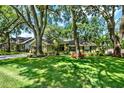 Charming home features lush lawn, mature trees, tidy landscaping, and a two-car garage at 1608 Victoria Way, Winter Garden, FL 34787