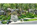 Charming home features lush lawn, mature trees, tidy landscaping, and a two-car garage at 1608 Victoria Way, Winter Garden, FL 34787