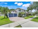 Beautiful two-story home with a brick driveway, well-maintained lawn, and a charming front entrance at 10252 Kristen Park Dr, Orlando, FL 32832