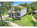Elegant two-story home with lush landscaping and a cozy front porch, perfect for relaxation at 10252 Kristen Park Dr, Orlando, FL 32832