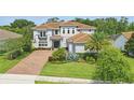 An upscale residence featuring well-manicured landscaping, paver driveway, and a two-car garage at 108 Stanton Estates Cir, Winter Garden, FL 34787