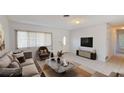 Bright living room features tile flooring, a plush sofa, a large window, and modern decor for a comfortable living space at 1119 Edith Dr, Daytona Beach, FL 32117