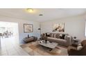 Bright living room with neutral decor and tile floors offers a modern, welcoming space at 1119 Edith Dr, Daytona Beach, FL 32117