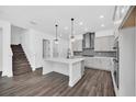 Open kitchen featuring a quartz island, stainless steel appliances, and modern light fixtures at 13081 Sunrise Harvest Dr, Winter Garden, FL 34787