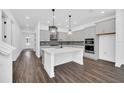Modern kitchen featuring sleek grey cabinetry, stainless steel appliances, and a quartz island at 13081 Sunrise Harvest Dr, Winter Garden, FL 34787