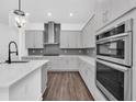 Close up on the kitchen with gray cabinets and new stainless steel appliances at 13081 Sunrise Harvest Dr, Winter Garden, FL 34787