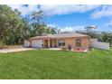 Well-maintained home with a verdant lawn and beautiful landscaping at 1395 Deland Ave, Orange City, FL 32763