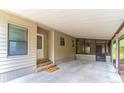 Spacious carport featuring a covered entryway, concrete flooring, and access to both the house and screened in porch at 149 E Plantation Blvd, Lake Mary, FL 32746