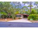 Charming single-story home featuring a well-maintained front yard with mature trees and a long driveway at 149 E Plantation Blvd, Lake Mary, FL 32746