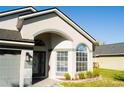 Inviting entrance with decorative door and large windows offering ample natural light at 149 Southampton Dr, Kissimmee, FL 34744