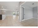 Open-concept living room featuring neutral gray walls, ceramic tile flooring, and recessed lighting at 15250 Aquarius Way, Mascotte, FL 34753