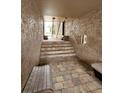 Building entrance showcasing brick pathway, benches, and stairway access to units at 155 N Pearl Lake Cswy # 104, Altamonte Springs, FL 32714