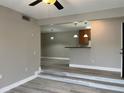 Bright living room with modern flooring, and partial kitchen view at 155 N Pearl Lake Cswy # 104, Altamonte Springs, FL 32714