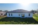 Spacious backyard of a single-Gathering home, featuring a well-kept lawn and a simple, modern exterior at 16367 Sw 17Th Terrace Rd, Ocala, FL 34473
