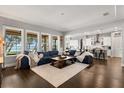 Open-concept living room with dark hardwood floors, large windows and view of the lake at 16761 Broadwater Ave, Winter Garden, FL 34787