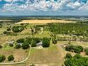 Expansive acreage with lush landscaping, mature trees, and an elegant home, showcasing the property's size and potential at 17524 Seidner Rd, Winter Garden, FL 34787