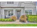 Inviting front entrance featuring decorative plants, a charming porch, and a neatly brick-paved walkway at 17537 Sailfin Dr, Orlando, FL 32820