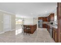 Open kitchen with granite countertops, stainless steel appliances, and an island with bar seating at 181 W Minnehaha Ave, Clermont, FL 34711
