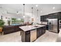 Open-concept kitchen with a large island, stainless steel appliances, and seamless flow to the living area and pool at 2156 Antilles Club Dr, Kissimmee, FL 34747