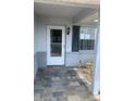Charming front porch features slate tile flooring, a white door, and a dark shutter at 2233 N Normandy Blvd, Deltona, FL 32725