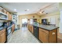 Open kitchen with a large island, stainless steel appliances, and a view into the dining and living areas at 2354 Barons Ct, Tavares, FL 32778