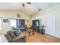 Spacious living room with light walls, ceiling fan, sliding glass doors and comfortable furnishings at 2354 Barons Ct, Tavares, FL 32778