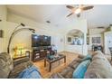 Bright living room featuring hardwood floors, a ceiling fan, and an archway leading to another room at 2354 Barons Ct, Tavares, FL 32778