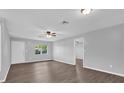 Cozy living room with a window, ceiling fan, and wood-look flooring at 2357 E Dana Dr, Deltona, FL 32738