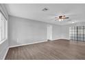 Bright living room featuring stylish wood-look flooring and a modern ceiling fan at 2357 E Dana Dr, Deltona, FL 32738