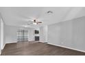 Open-concept living area with wood-look floors and views of the adjacent kitchen at 2357 E Dana Dr, Deltona, FL 32738