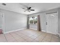 Bright and airy living room with tile flooring and ample natural light at 245 Amador Cir, Orlando, FL 32810