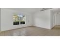 Bright living room with tile flooring, natural light from a large window, and neutral paint at 250 Hickory Ave, Orange City, FL 32763
