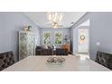 Open dining room featuring a modern light fixture and views into the living area at 2762 Pepper Ln, Orlando, FL 32812