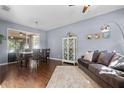 Open concept living room featuring hardwood floors, comfortable seating, and natural light at 2762 Pepper Ln, Orlando, FL 32812
