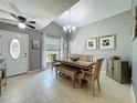 Inviting dining room featuring a vaulted ceiling and traditional style furniture with a view from the window at 293 Drosdick Dr, Casselberry, FL 32707