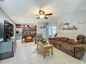 Open concept living area with a cozy sofa and open view to the kitchen, perfect for entertaining guests at 293 Drosdick Dr, Casselberry, FL 32707