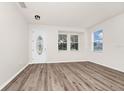 Bright living room featuring wood-look floors, neutral walls, and windows for natural light at 309 Black Springs Ln, Winter Garden, FL 34787
