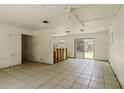 Open-concept layout with a partial kitchen view and sliding glass doors to the backyard at 315 Panama Cir, Winter Springs, FL 32708