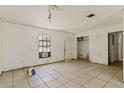 Bright living room featuring tile flooring, an exterior door, and a window with natural light at 315 Panama Cir, Winter Springs, FL 32708