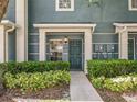 Inviting entrance to townhome with well-maintained landscaping and exterior lighting at 3309 Wilshire Way Rd # 3, Orlando, FL 32829