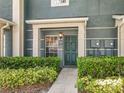 Exterior entrance featuring updated door, attractive landscaping, and traditional design at 3309 Wilshire Way Rd # 3, Orlando, FL 32829